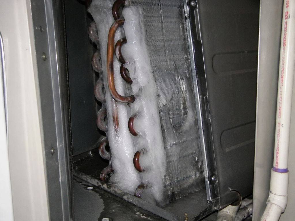 Frozen evaporator coil with ice buildup – AC running but not cooling